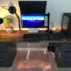 Aesthetic craft Modern gaming desk with dark brown wooden top and black drawer units, dual monitor setup shown.