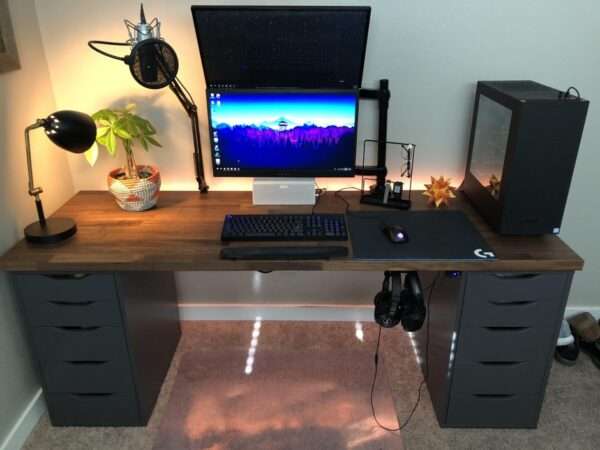 Aesthetic craft Modern gaming desk with dark brown wooden top and black drawer units, dual monitor setup shown.