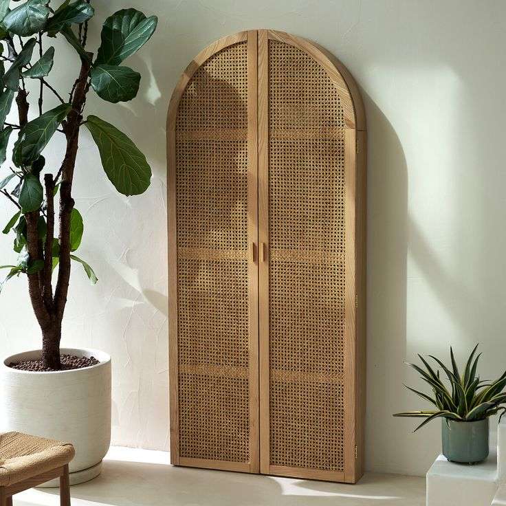 Foldable oak and rattan cabinet desk with brass handles, closed against a wall Aeshtetic craft