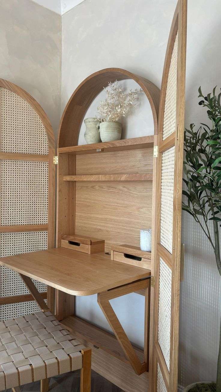 Foldable oak and rattan cabinet desk with brass handles, closed against a wall Aeshtetic craft