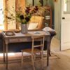 Antique-writing desk with drawer, hand-carved details, and aged oak oil finish