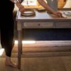 Antique-writing desk with drawer, hand-carved details, and aged oak oil finish