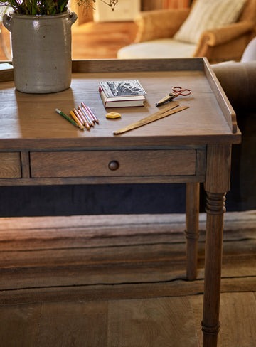 Antique-writing desk with drawer, hand-carved details, and aged oak oil finish