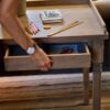 Antique-writing desk with drawer, hand-carved details, and aged oak oil finish