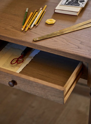 Antique-writing desk with drawer, hand-carved details, and aged oak oil finish