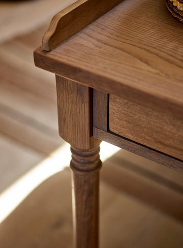 Antique-writing desk with drawer, hand-carved details, and aged oak oil finish