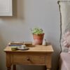 bedside table in natural pine wood with slim drawer, brass hardware, and bottom shelf