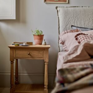 bedside table in natural pine wood with slim drawer, brass hardware, and bottom shelf