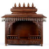 puja temple in dark brown finish with detailed carvings and dangling brass bells