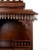 puja temple in dark brown finish with detailed carvings and dangling brass bells