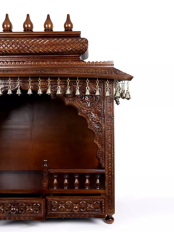 puja temple in dark brown finish with detailed carvings and dangling brass bells