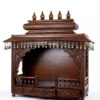 puja temple in dark brown finish with detailed carvings and dangling brass bells