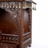 puja temple in dark brown finish with detailed carvings and dangling brass bells