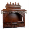 puja temple in dark brown finish with detailed carvings and dangling brass bells
