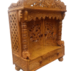 Handcrafted teak wood pooja mandir with peacock carving and doors, high gloss finish
