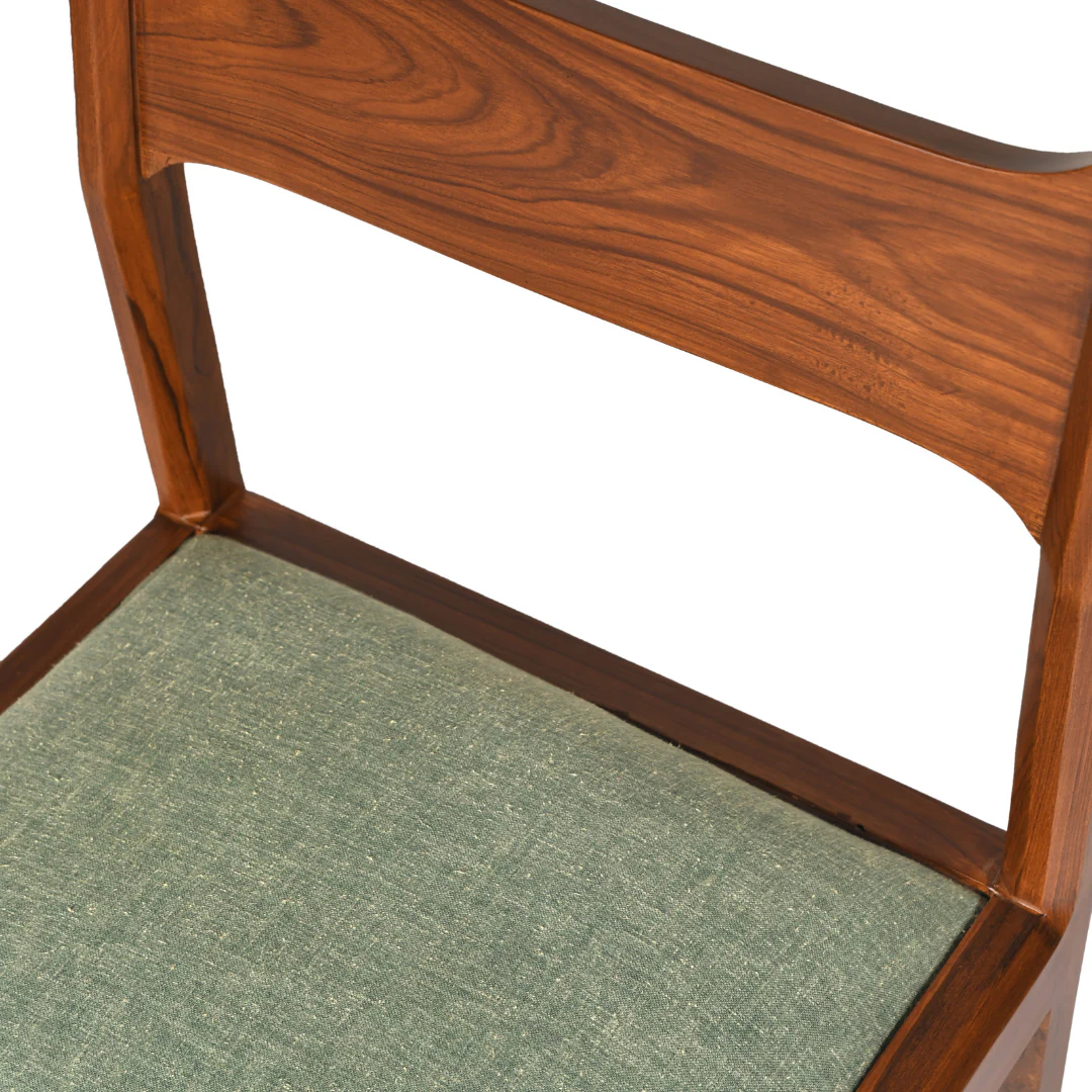 Teak wood dining table set with 4 chairs and 1 bench in brown finish and green cushioned seats.