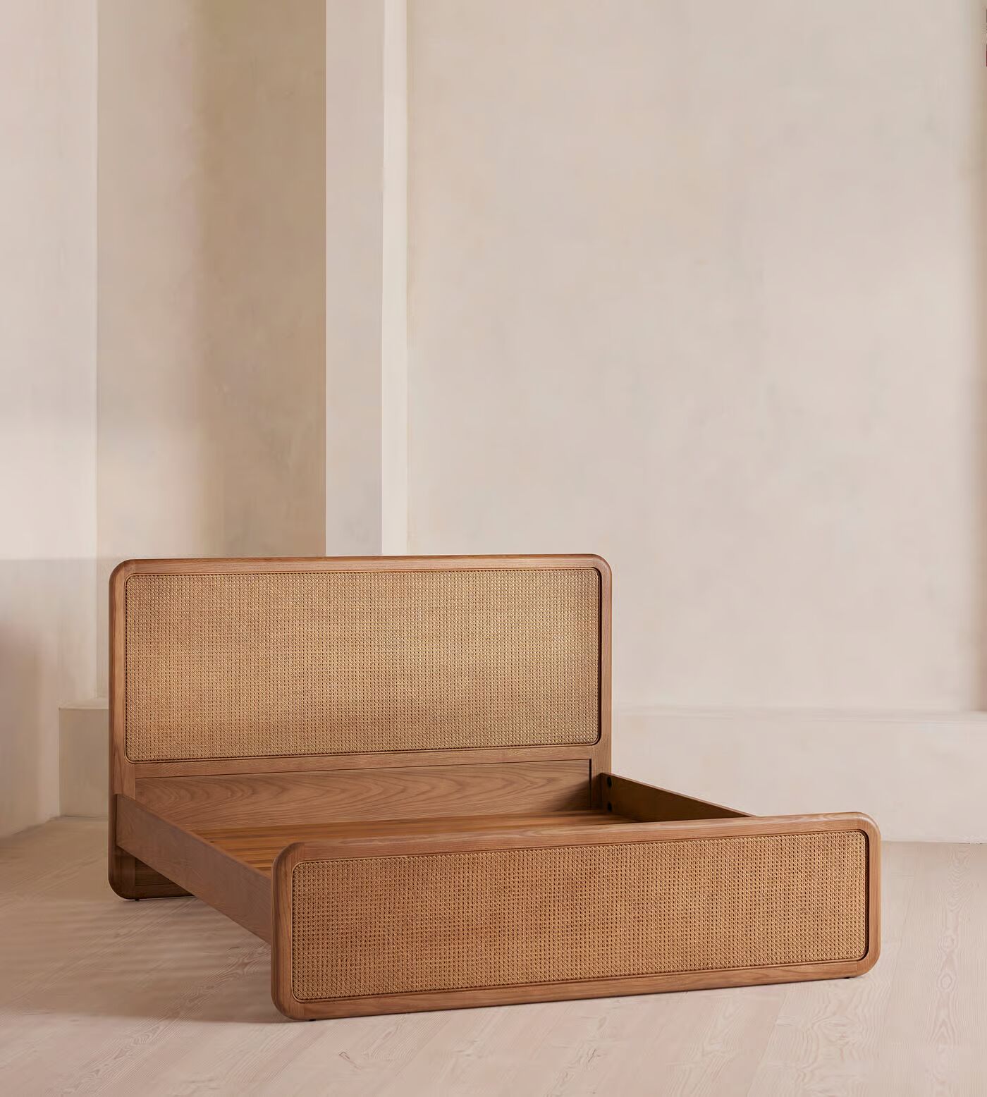 Cane bed made of teak wood with handwoven rattan headboard and brown finish Cane bed made of teak wood with handwoven rattan headboard and brown finish