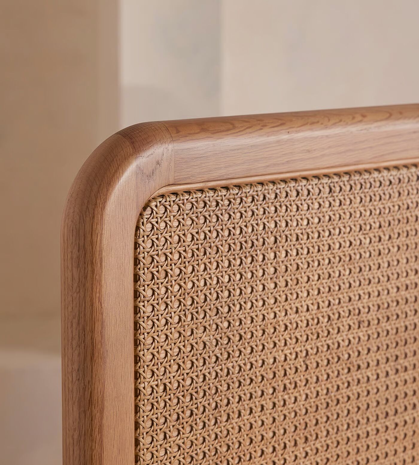 Cane bed made of teak wood with handwoven rattan headboard and brown finish Cane bed made of teak wood with handwoven rattan headboard and brown finish