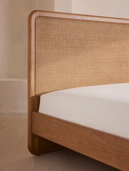 Cane bed made of teak wood with handwoven rattan headboard and brown finish Cane bed made of teak wood with handwoven rattan headboard and brown finish