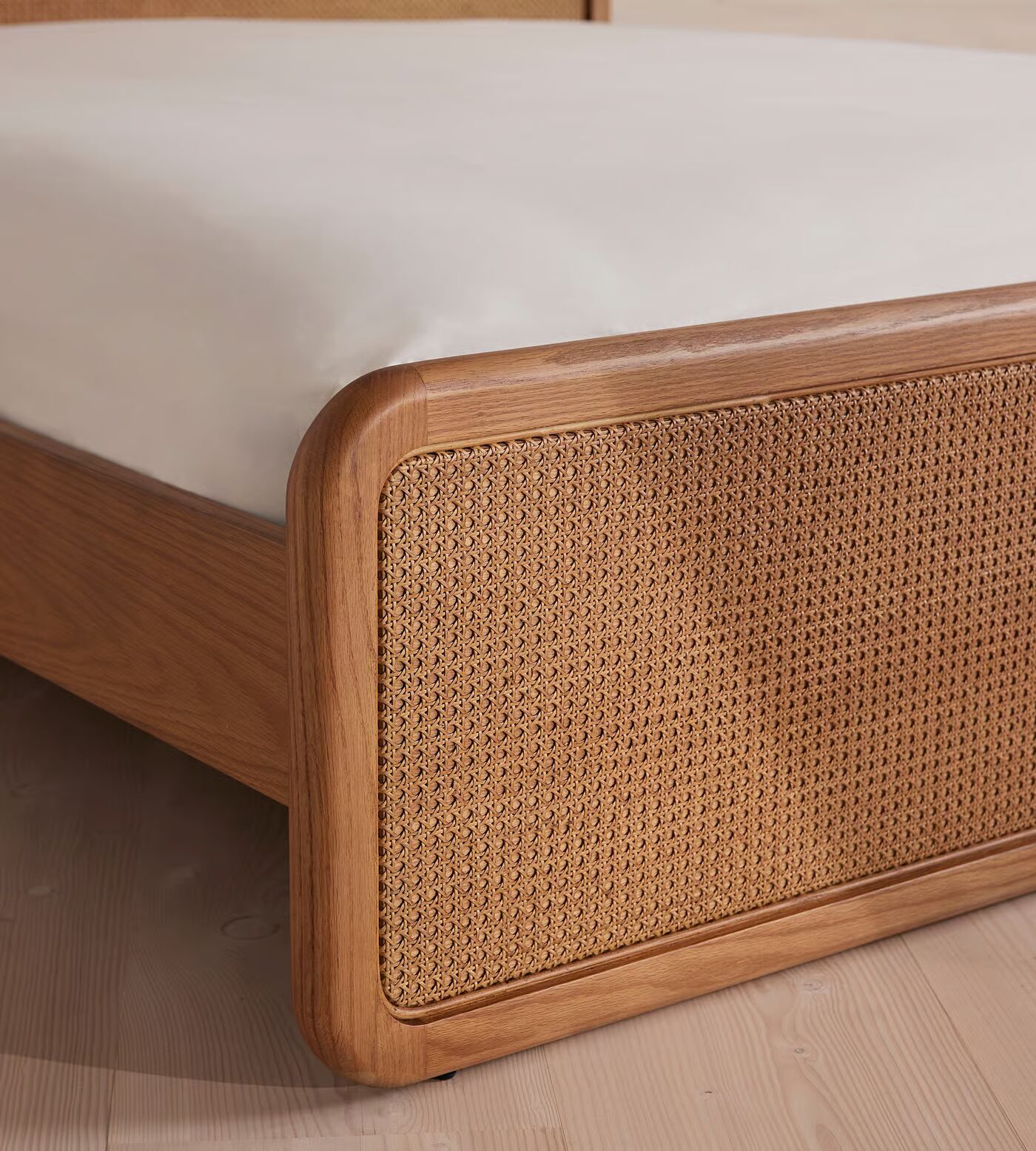 Cane bed made of teak wood with handwoven rattan headboard and brown finish Cane bed made of teak wood with handwoven rattan headboard and brown finish