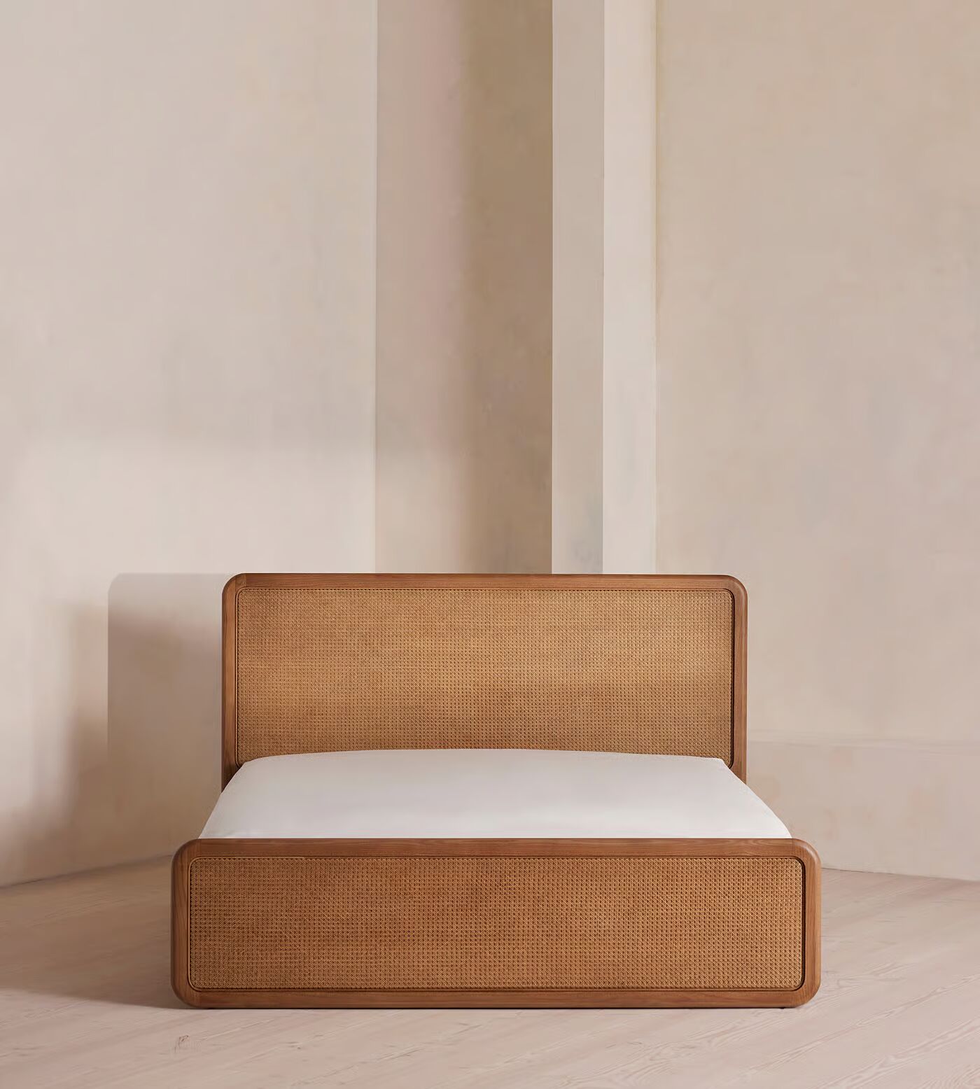 Cane bed made of teak wood with handwoven rattan headboard and brown finish Cane bed made of teak wood with handwoven rattan headboard and brown finish