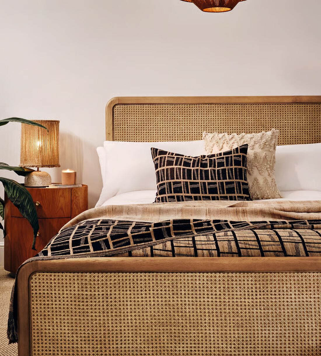 Cane bed made of teak wood with handwoven rattan headboard and brown finish Cane bed made of teak wood with handwoven rattan headboard and brown finish