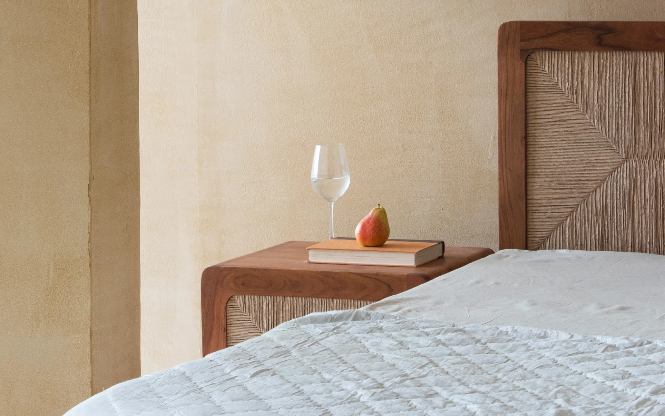 Queen size bed made of solid teak wood in natural finish with upholstered headboard — stylish and durable wooden bed for modern bedrooms. Queen size bed made of solid teak wood in natural finish with upholstered headboard — stylish and durable wooden bed for modern bedrooms.