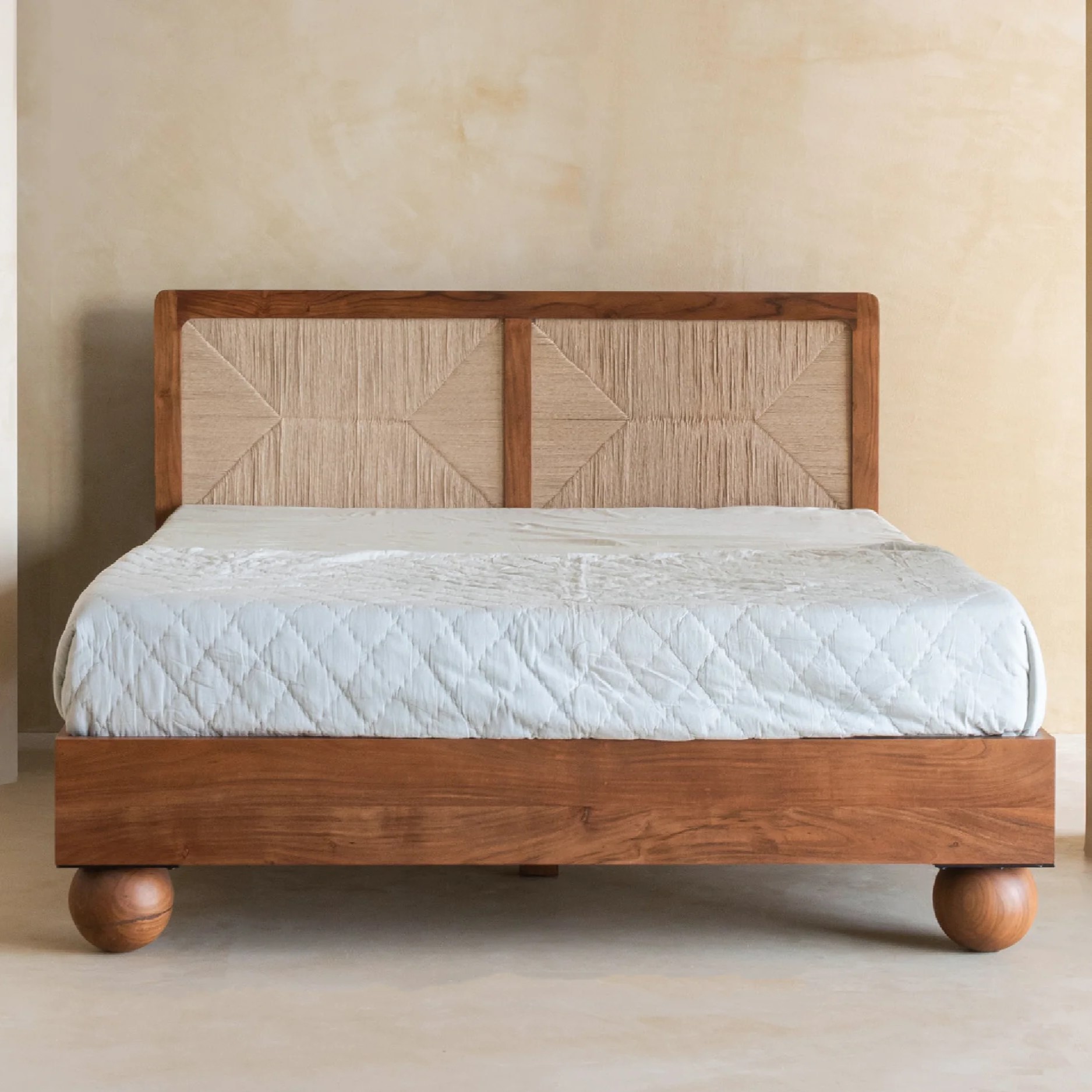 Queen size bed made of solid teak wood in natural finish with upholstered headboard — stylish and durable wooden bed for modern bedrooms.