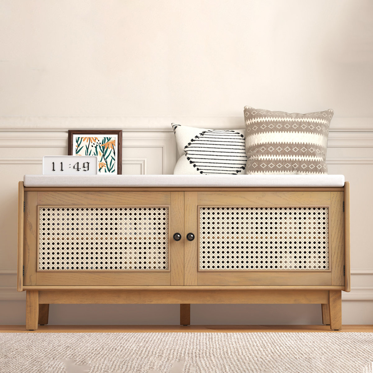 Teak wood shoe bench with natural cane cushion and two storage doors, shown in a modern entryway.