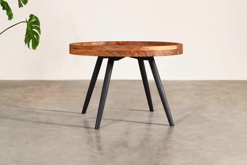 Round coffee table in teak wood with natural brown top and black legs Round coffee table in teak wood with natural brown top and black legs