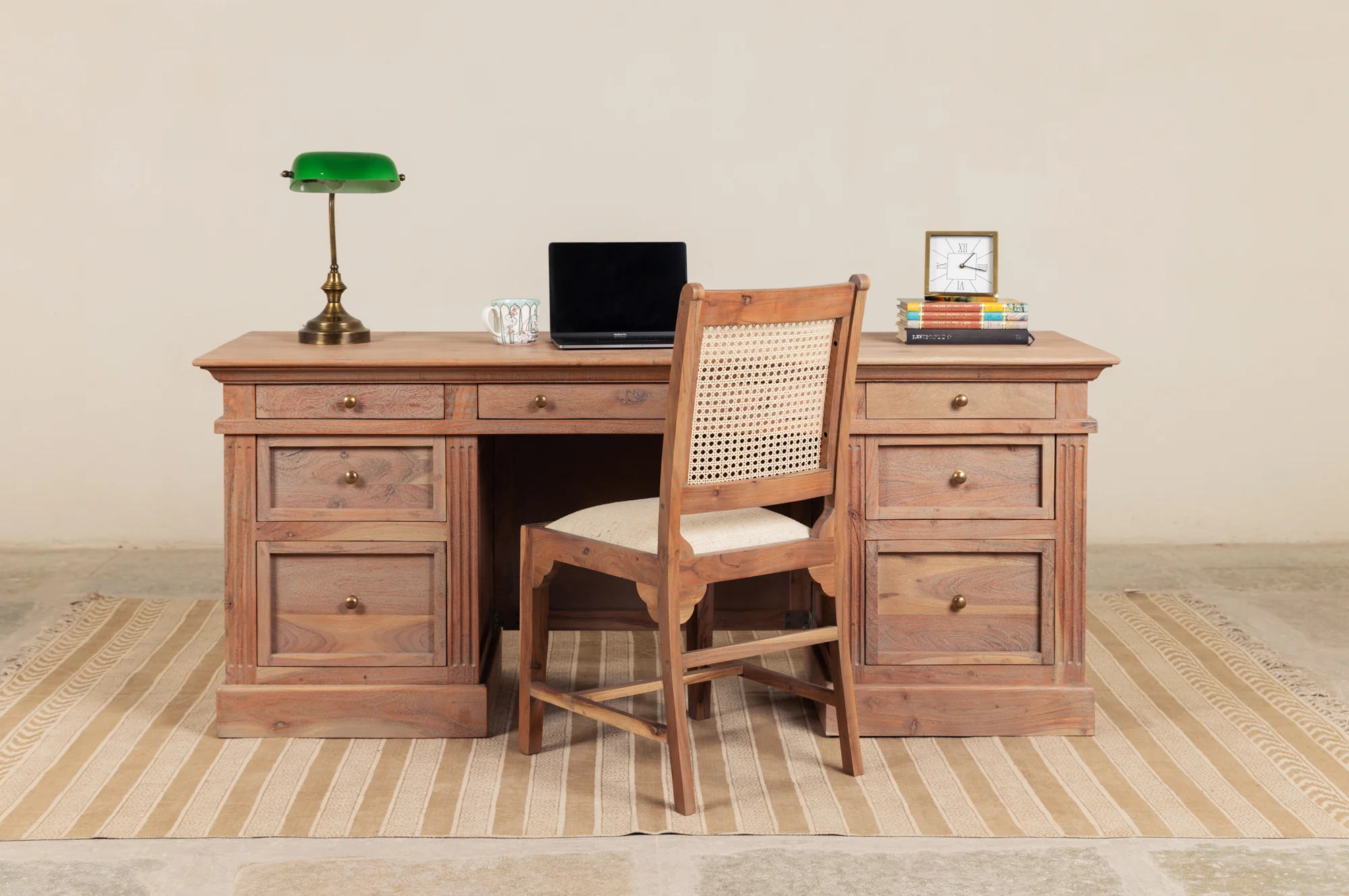 Wooden writing desk in solid teak wood with seven drawers and natural brown finish
