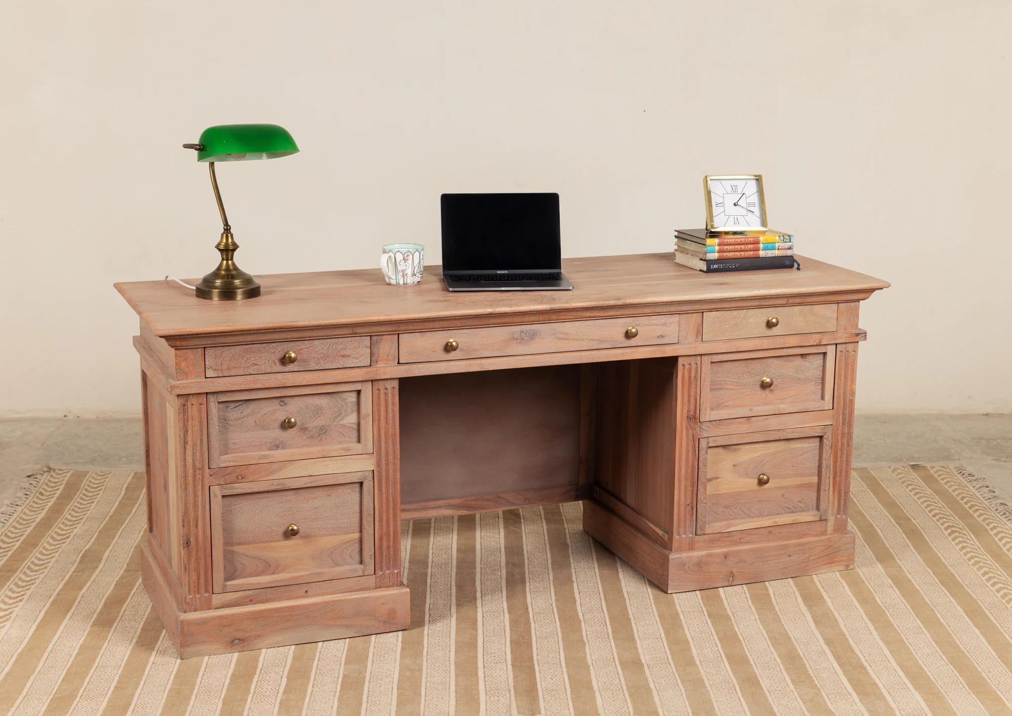 Wooden writing desk in solid teak wood with seven drawers and natural brown finish