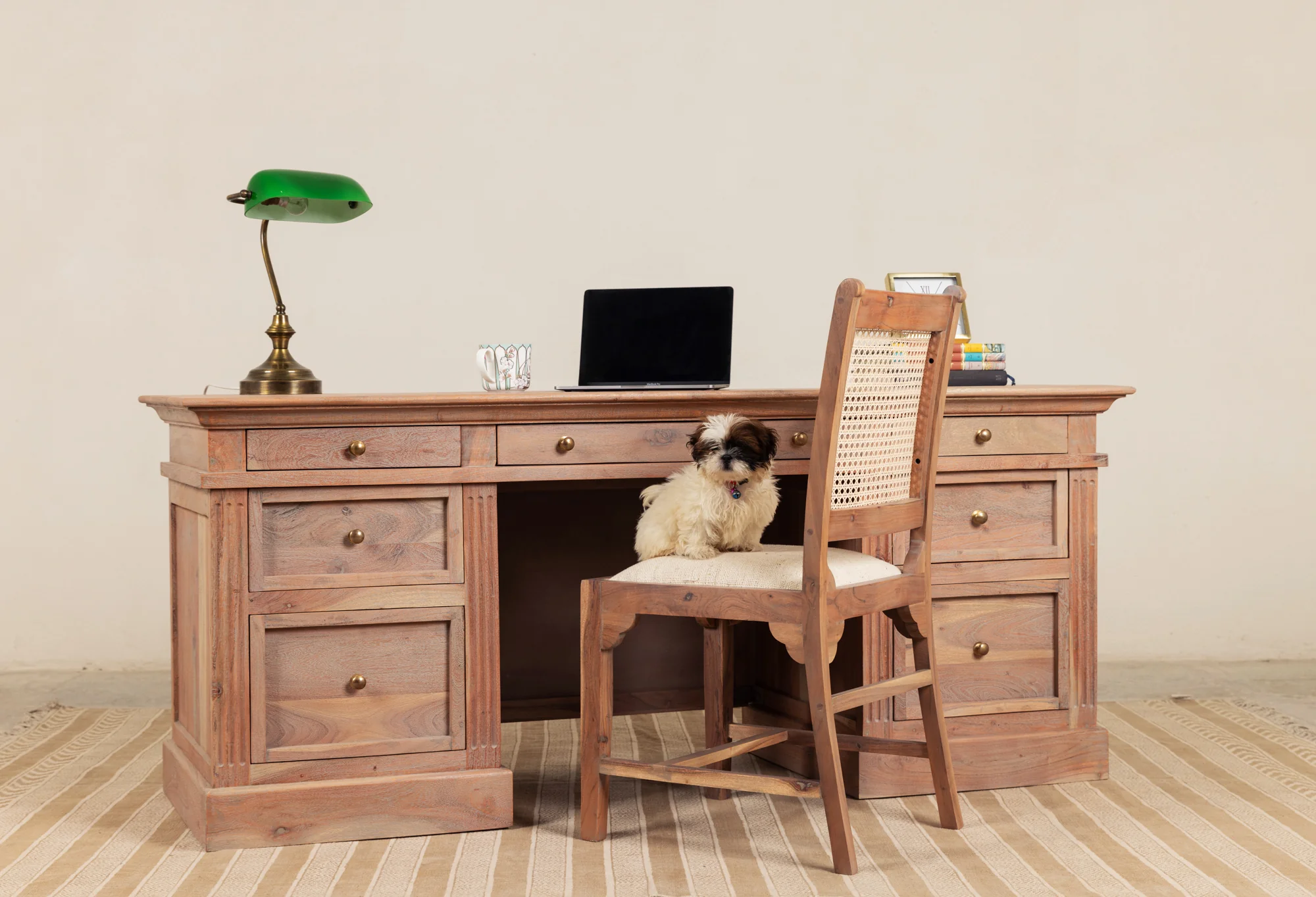 Wooden writing desk in solid teak wood with seven drawers and natural brown finish