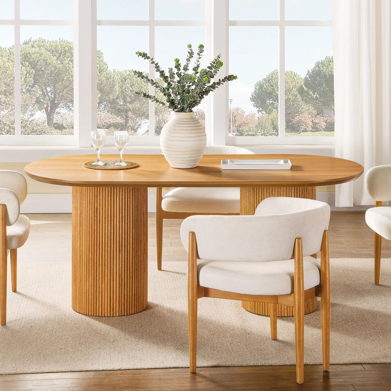Curved dining table in teak wood with natural finish