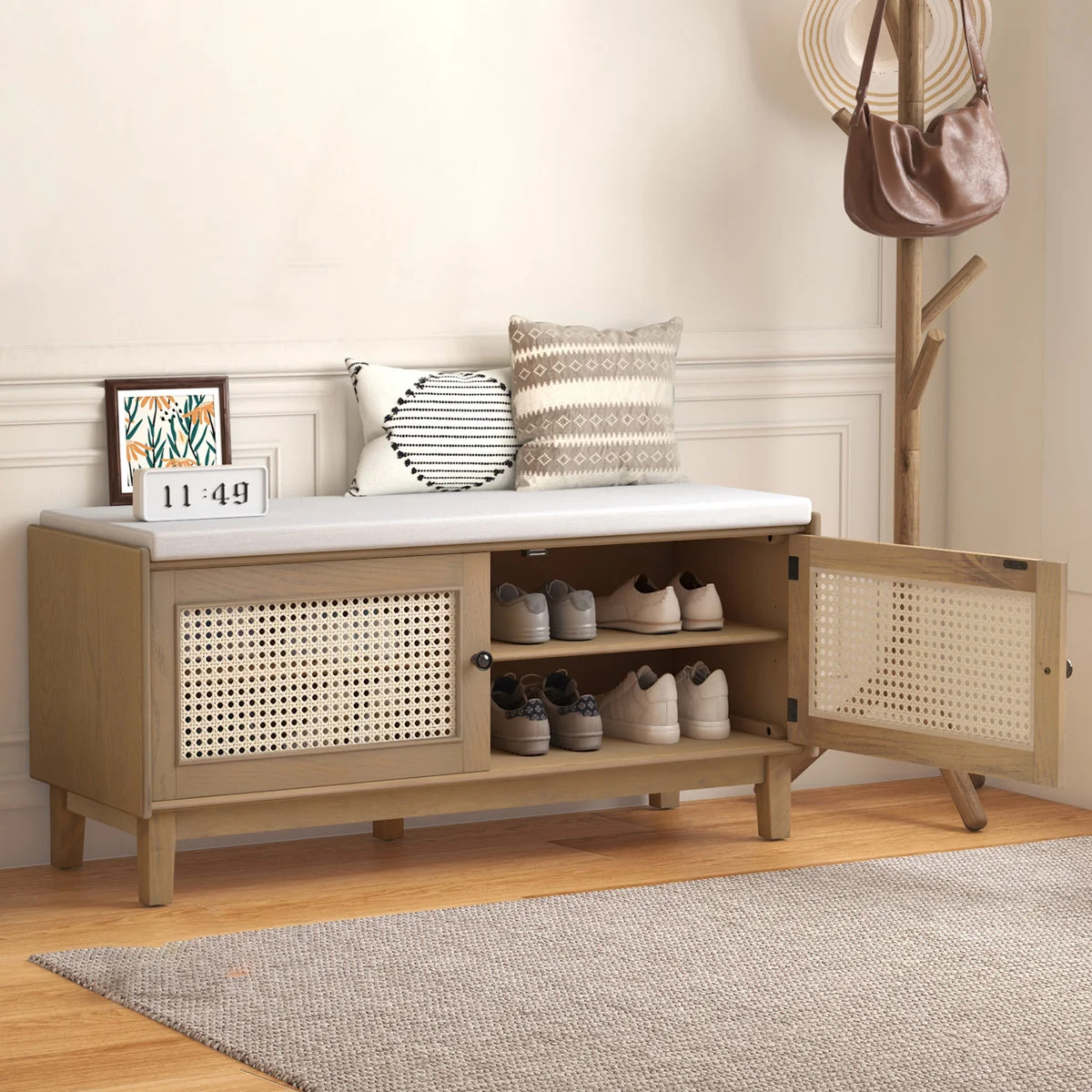 Teak wood shoe bench with natural cane cushion and two storage doors, shown in a modern entryway.